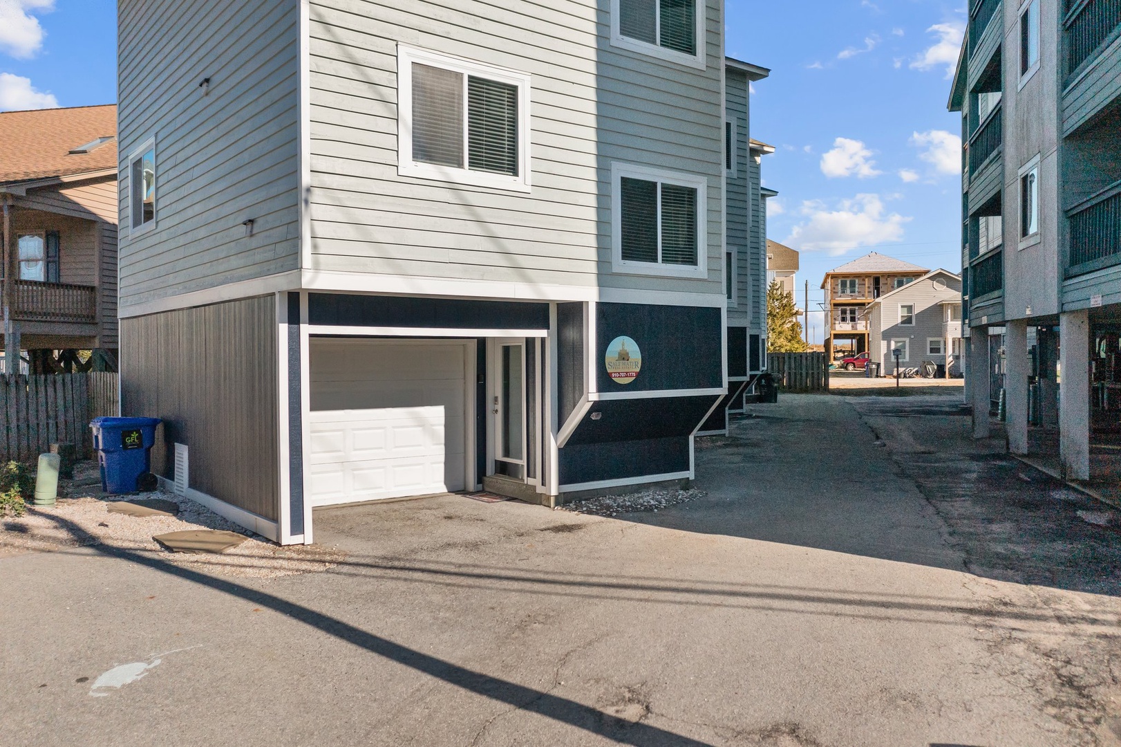 Modern beach house with convenient garage parking in a peaceful residential neighborhood near the shore.