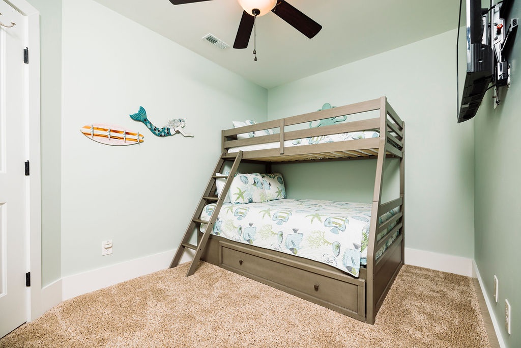 Your kids will love this ocean-themed room with cozy bunk beds, fun mermaid decor, and built-in storage drawers for all their treasures.