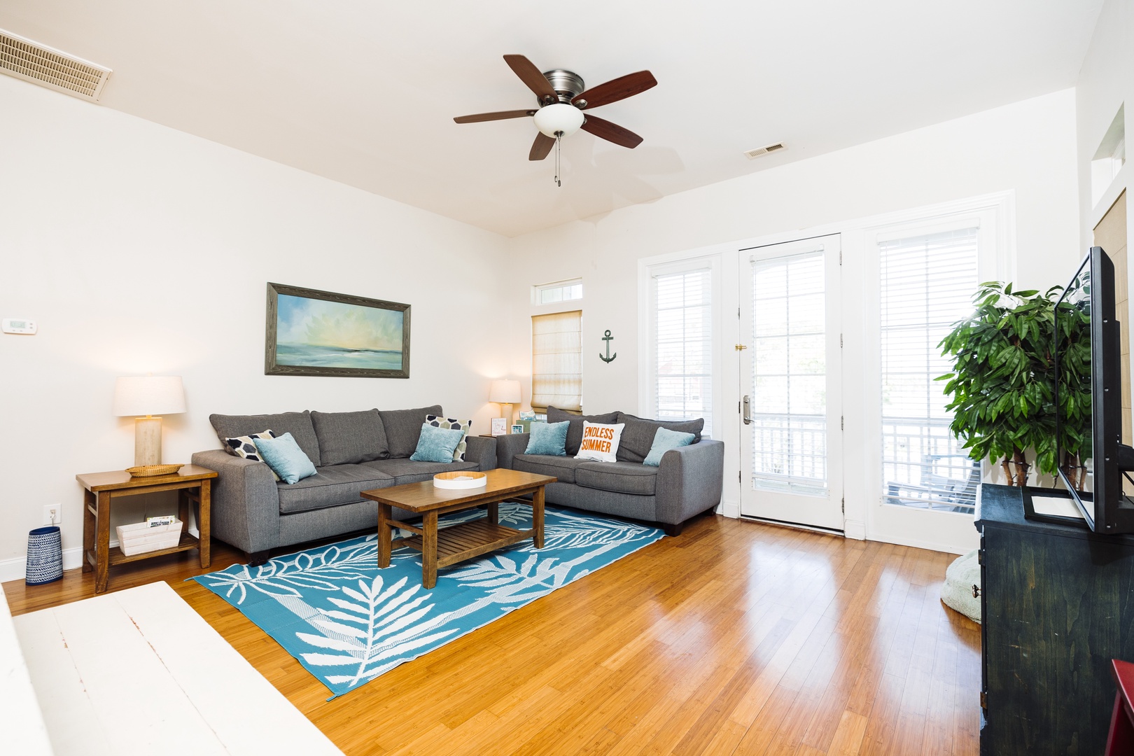Relax in your bright, airy living space with comfortable seating, tropical touches, and French doors opening to your private outdoor area.