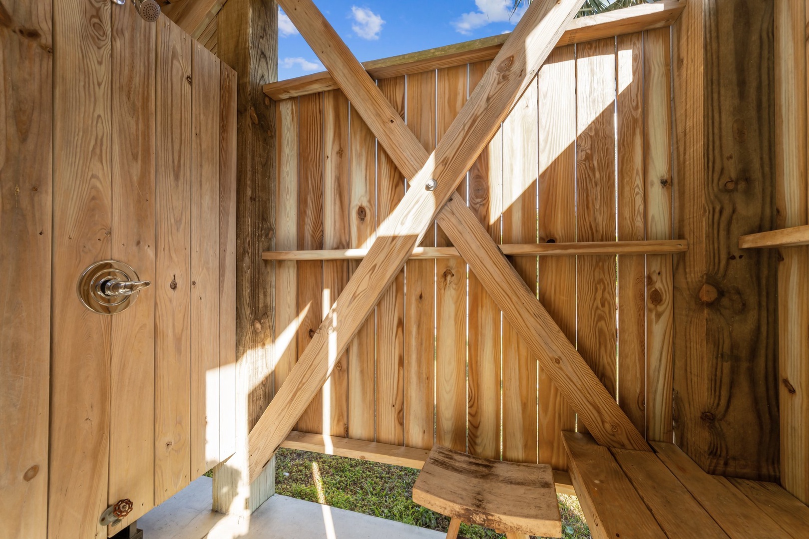 Step into your private outdoor shower surrounded by warm cedar walls and open sky above.