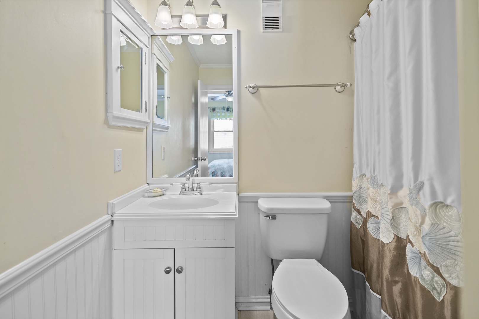 Refresh in your elegantly appointed bathroom with crisp white fixtures, warm coastal touches, and all the comforts you need.