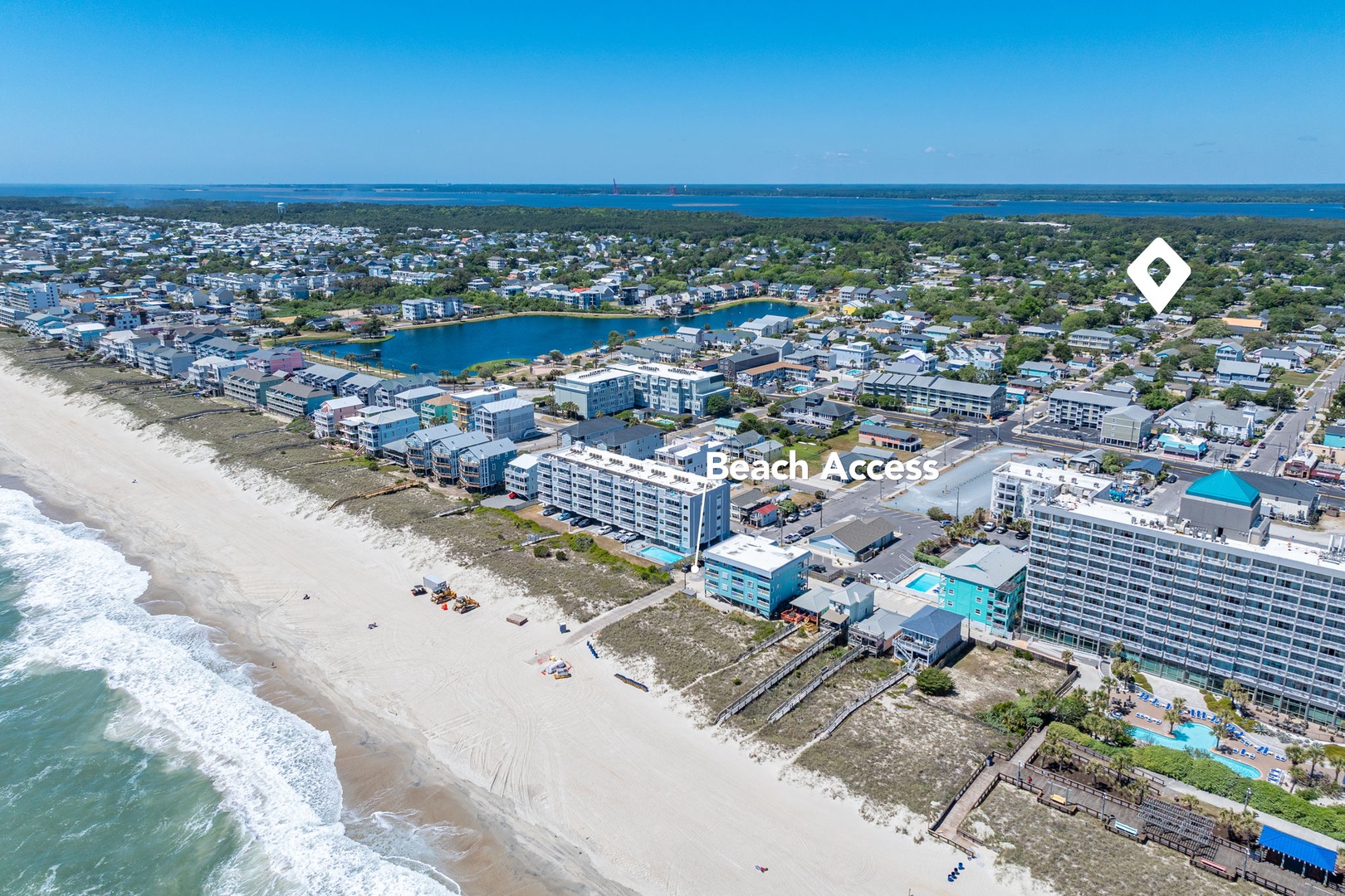 Aerial view showcasing the beachfront location with direct beach access and coastal community setting.