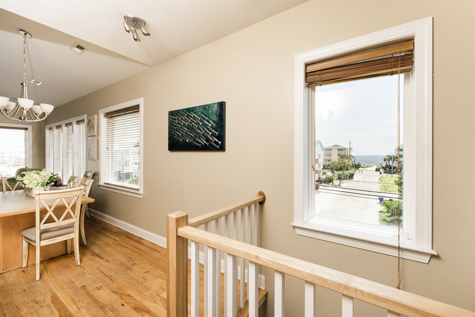 Enjoy your morning coffee at this bright dining nook, where warm wood tones and ocean glimpses create the perfect coastal retreat.