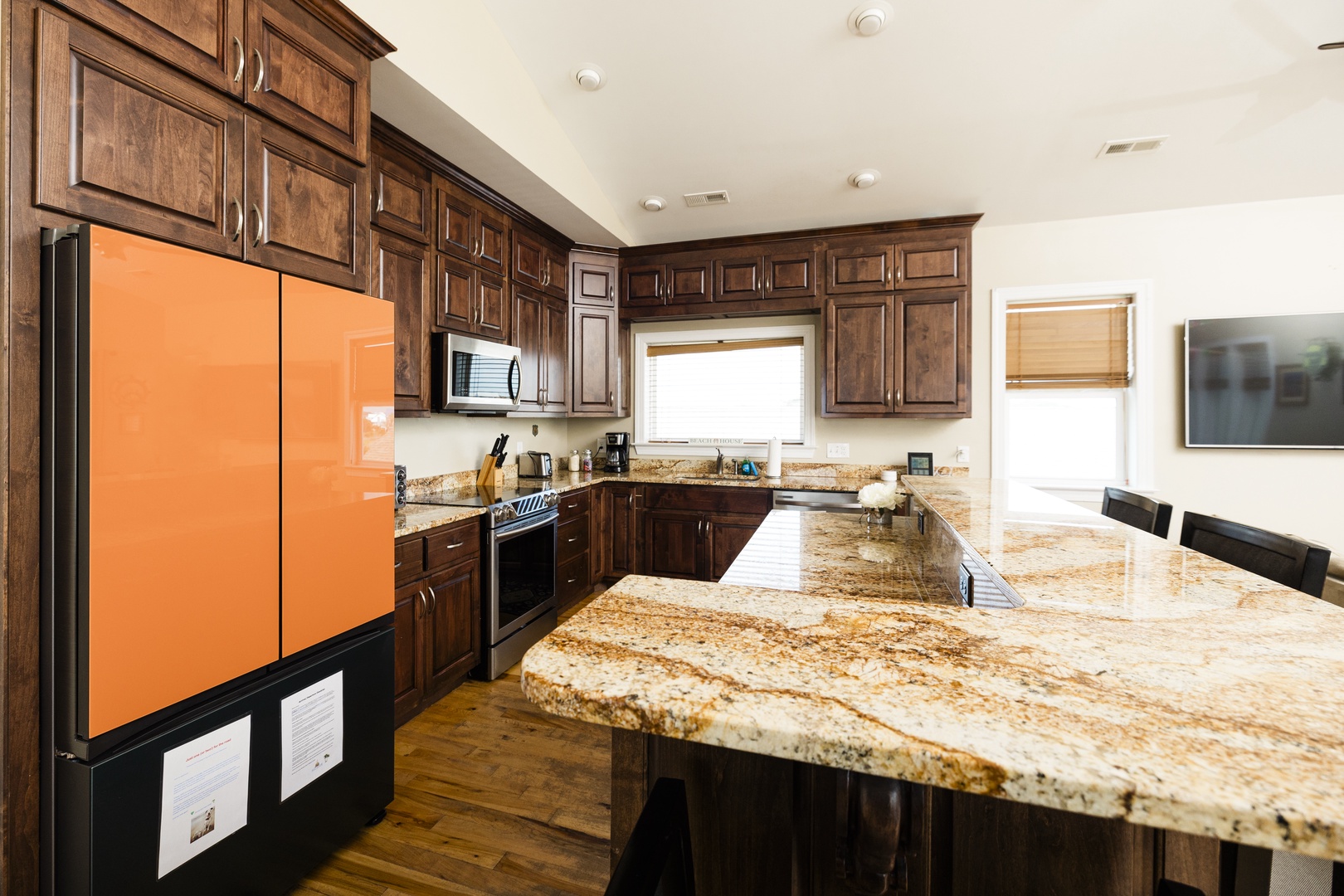 Your gourmet kitchen awaits with gleaming granite countertops, rich wood cabinetry, and modern appliances for memorable meal preparation.
