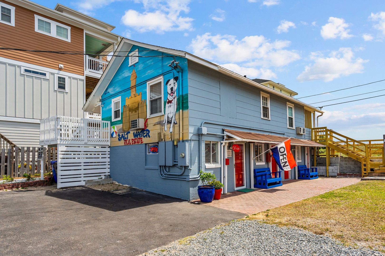 Colorful beachside property featuring vibrant murals and coastal charm in a welcoming neighborhood setting.