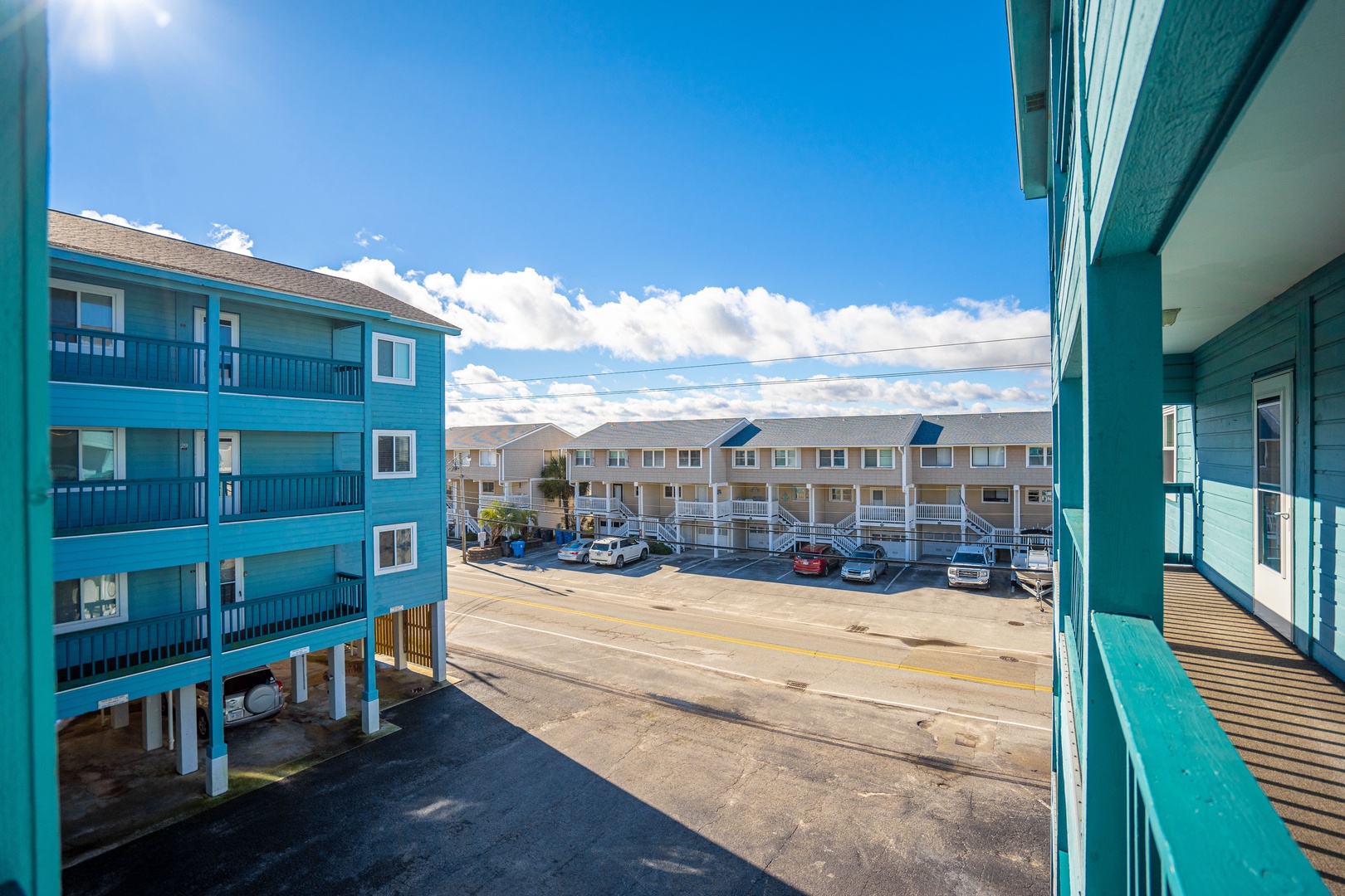 Bright coastal property complex with ample parking and convenient access to surrounding vacation rental buildings.