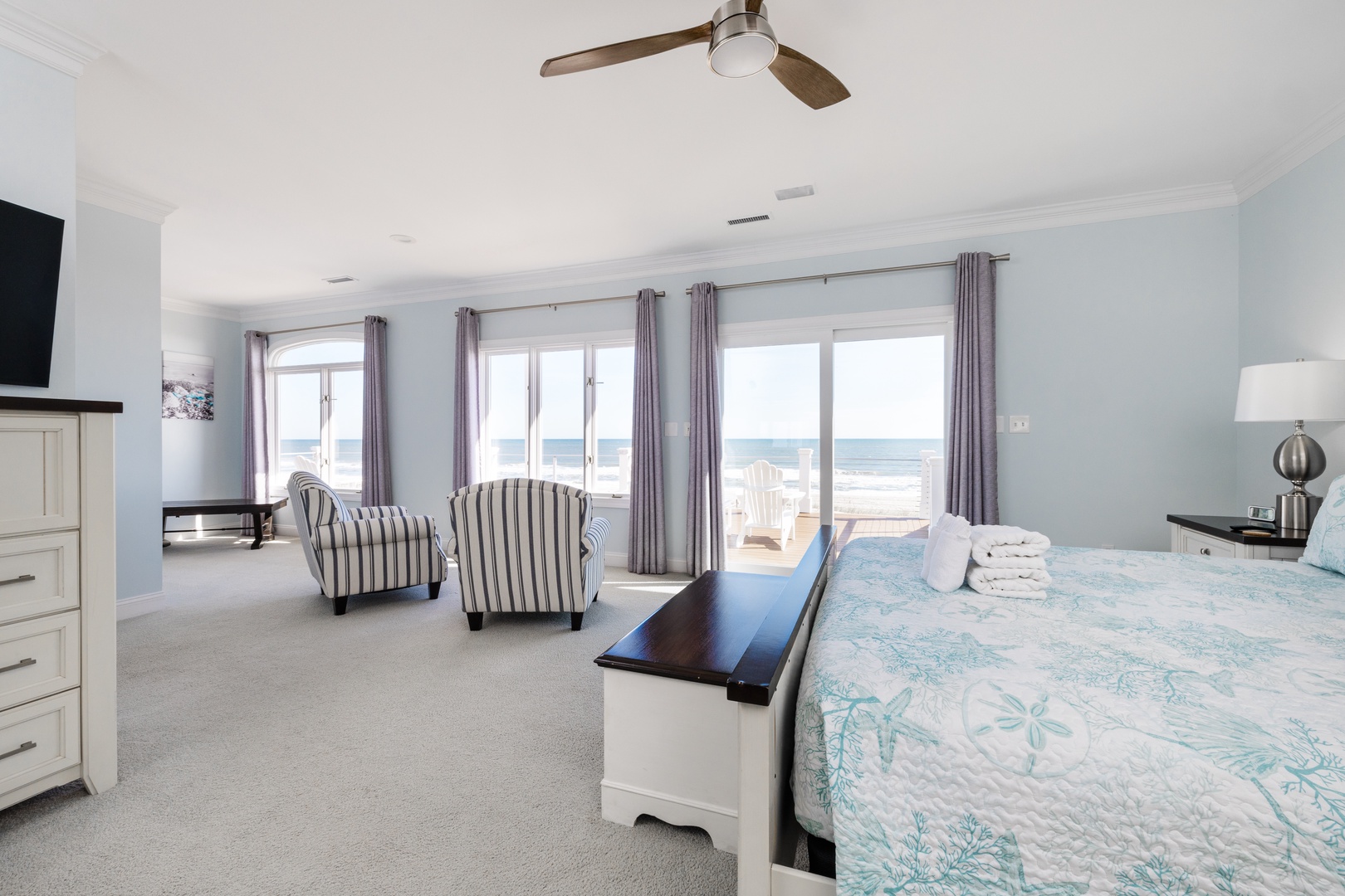 Wake up to stunning ocean views from your spacious bedroom, where gentle sea breezes through large windows create the perfect coastal retreat.