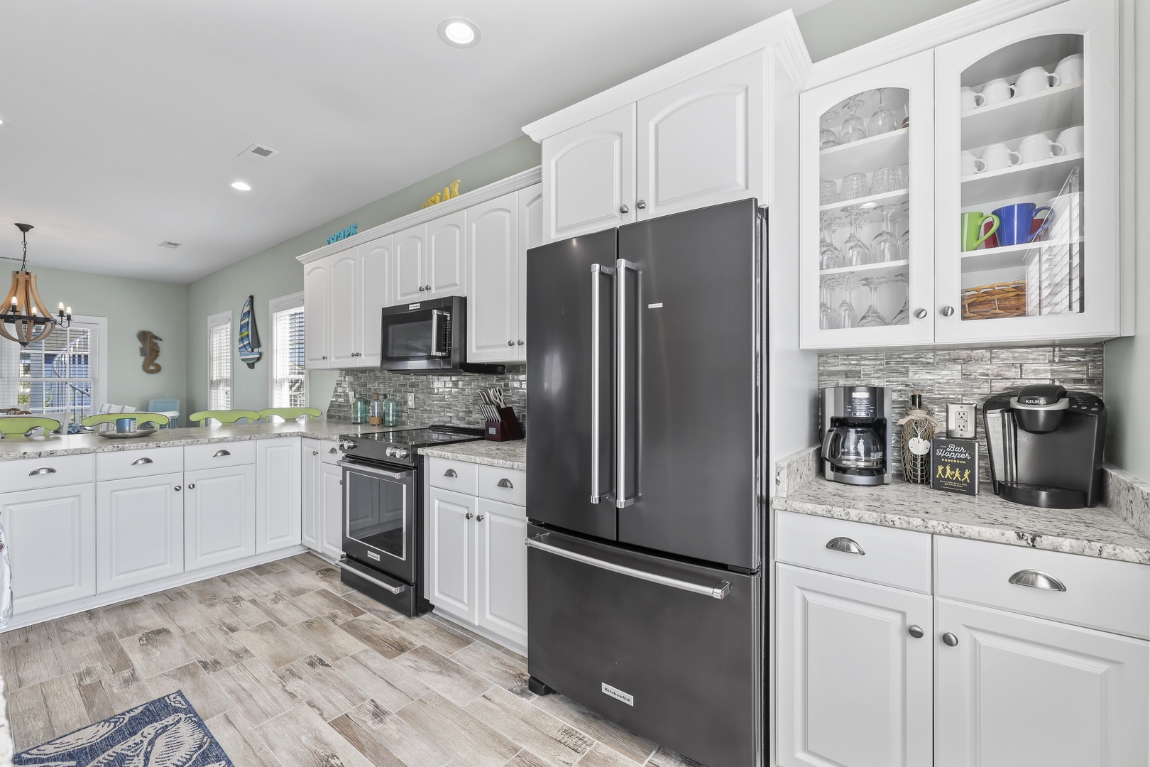 Picture yourself preparing your favorite meals in this bright, fully-equipped kitchen with modern appliances, ample counter space, and a cozy dining area that makes every morning coffee feel special.