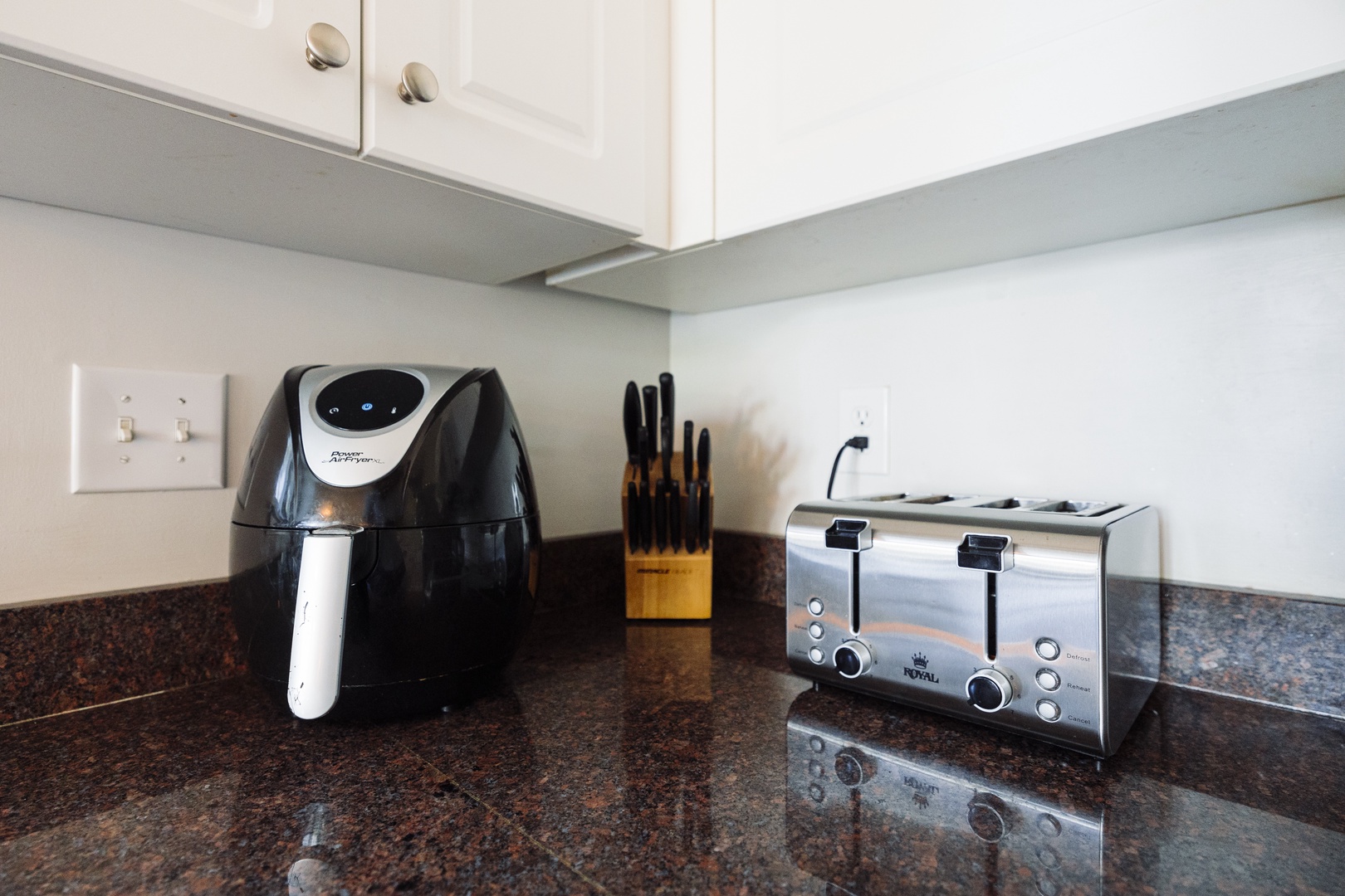 Your modern kitchen features a sleek air fryer and four-slice toaster, perfect for preparing delicious meals during your stay.
