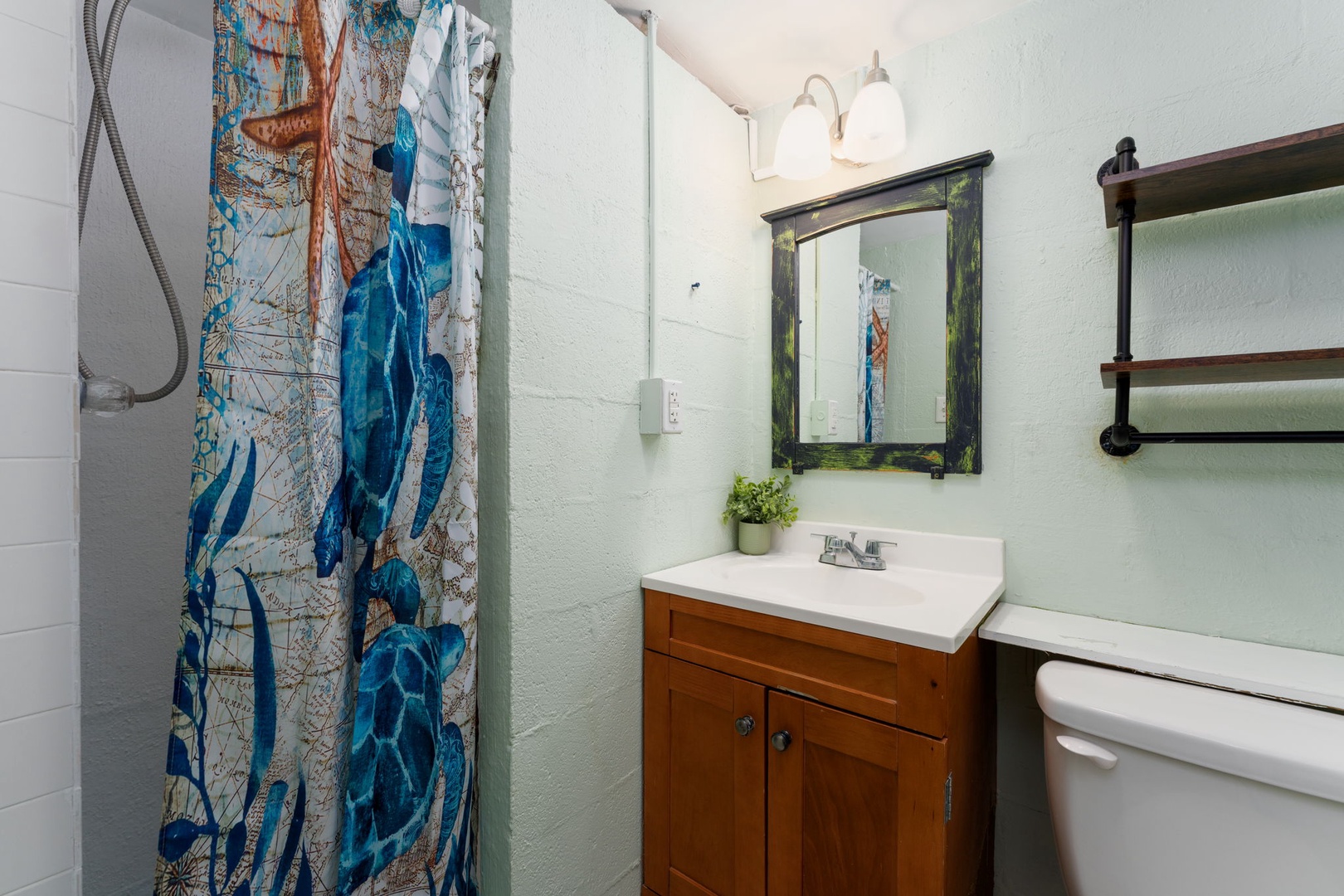 Refresh in your private bathroom with its charming coastal details and warm wood vanity.
