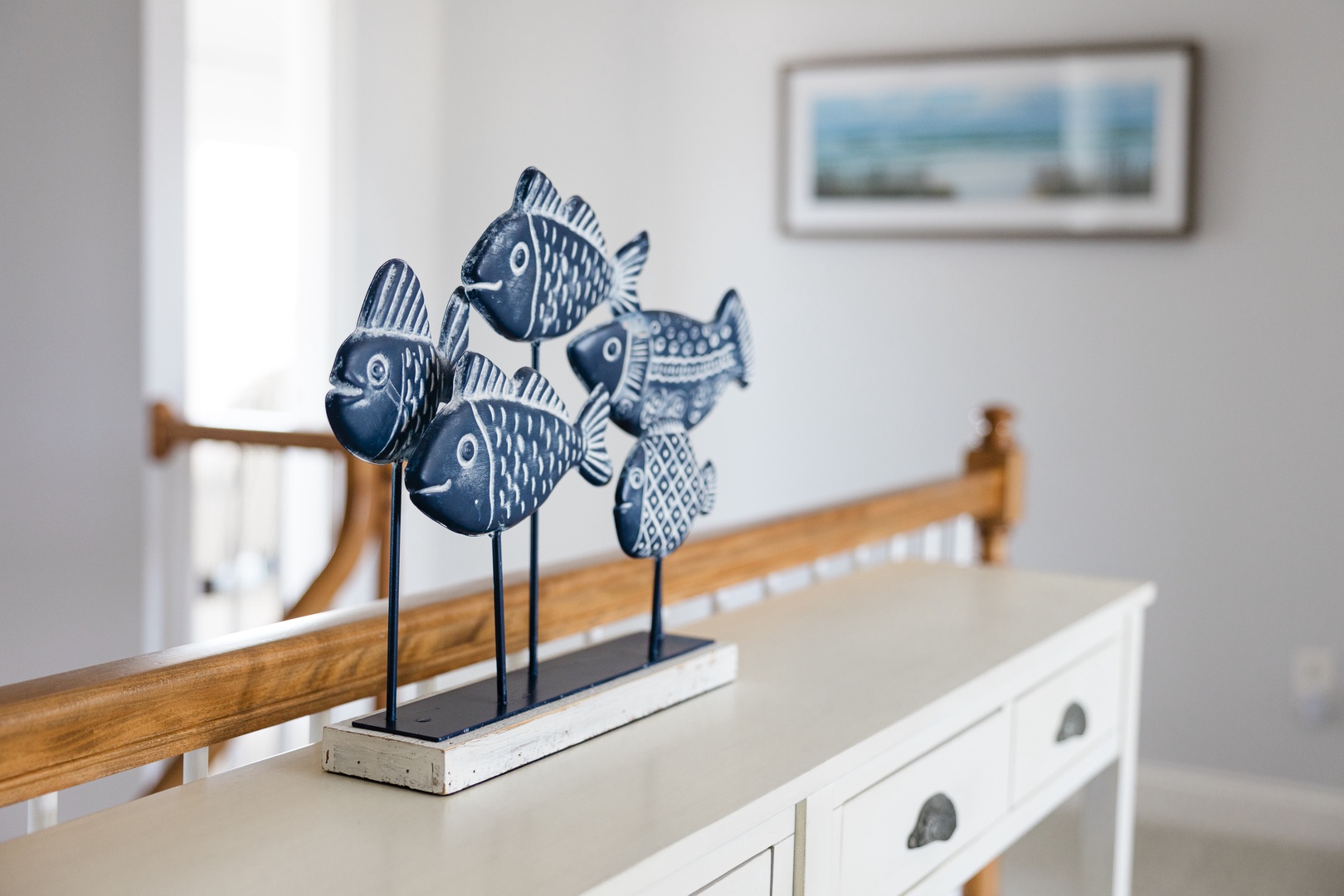 Charming nautical touches welcome you with whimsical fish sculptures that perfectly complement the coastal artwork adorning your peaceful retreat.