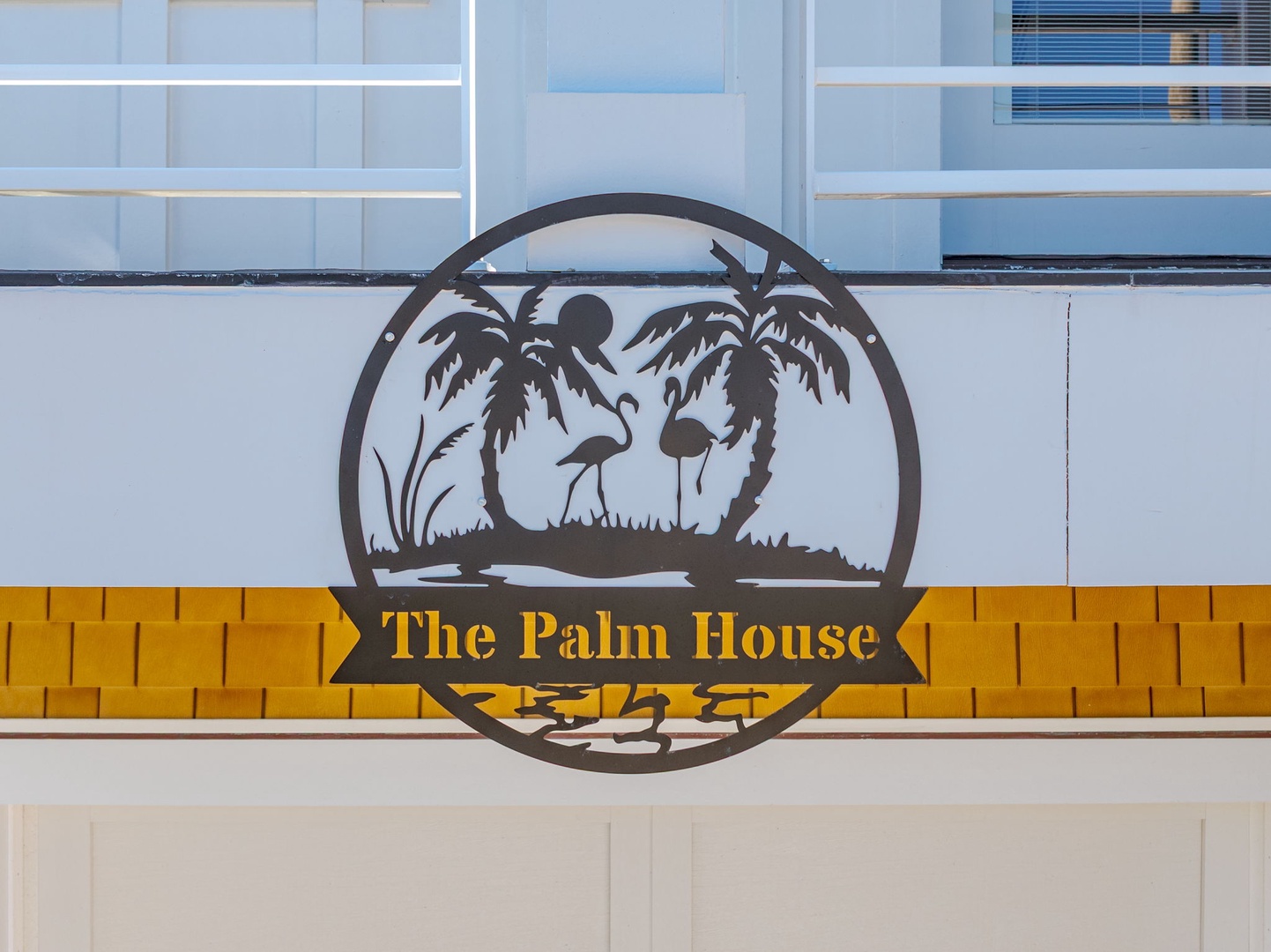 The Palm House's tropical-themed logo marks your arrival at this distinctive vacation destination.
