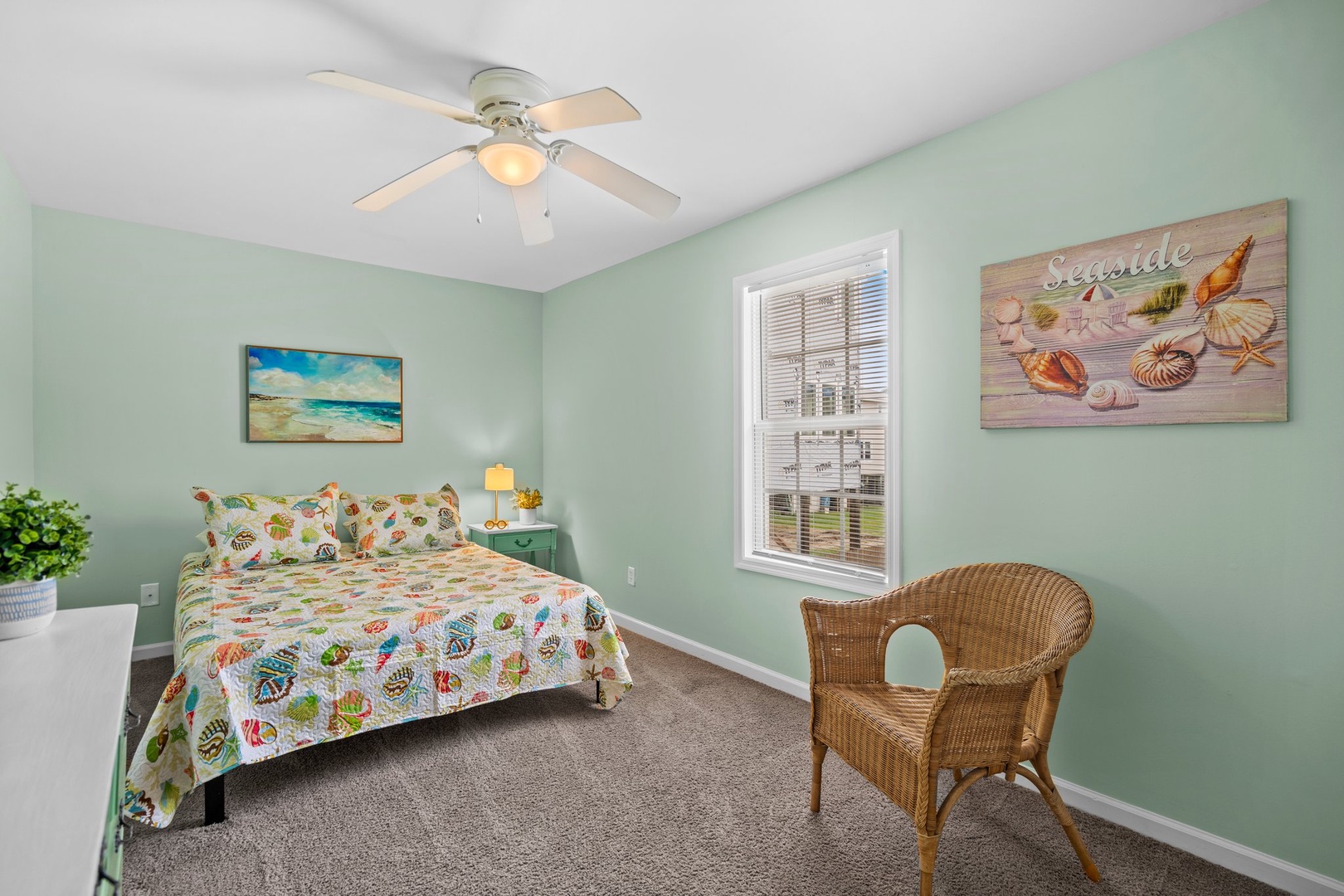Drift off in your seaside-themed bedroom, where ocean-inspired art and colorful shell bedding create a coastal sanctuary.