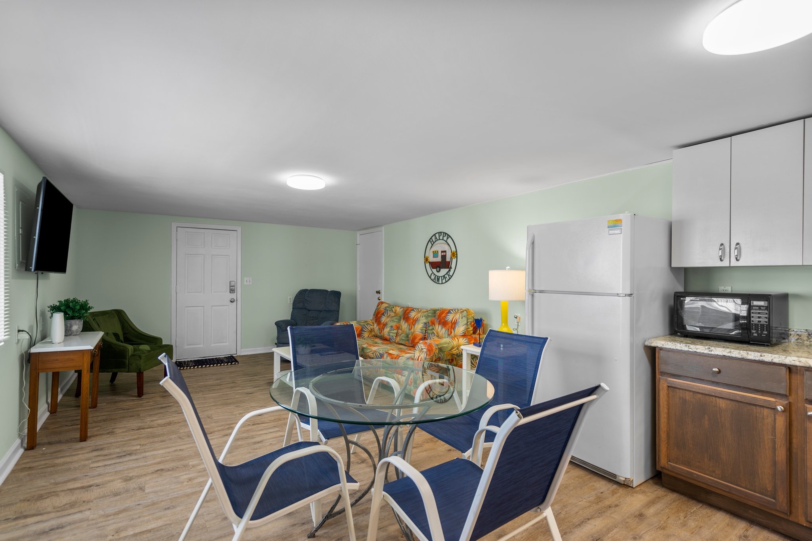 Your comfortable open-plan living space features a full kitchen, dining table for six, and cozy seating area perfect for relaxing after exploring.