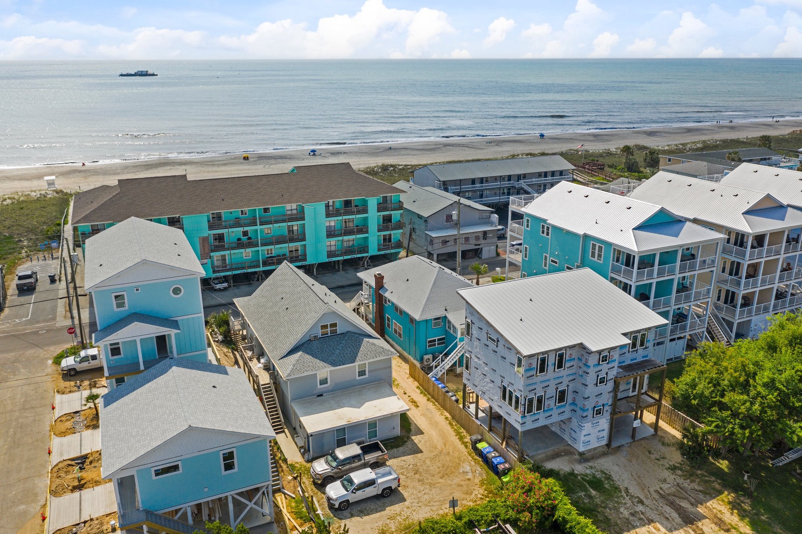 Coastal vacation rental properties situated steps from pristine beachfront, offering direct access to sandy shores and ocean views.