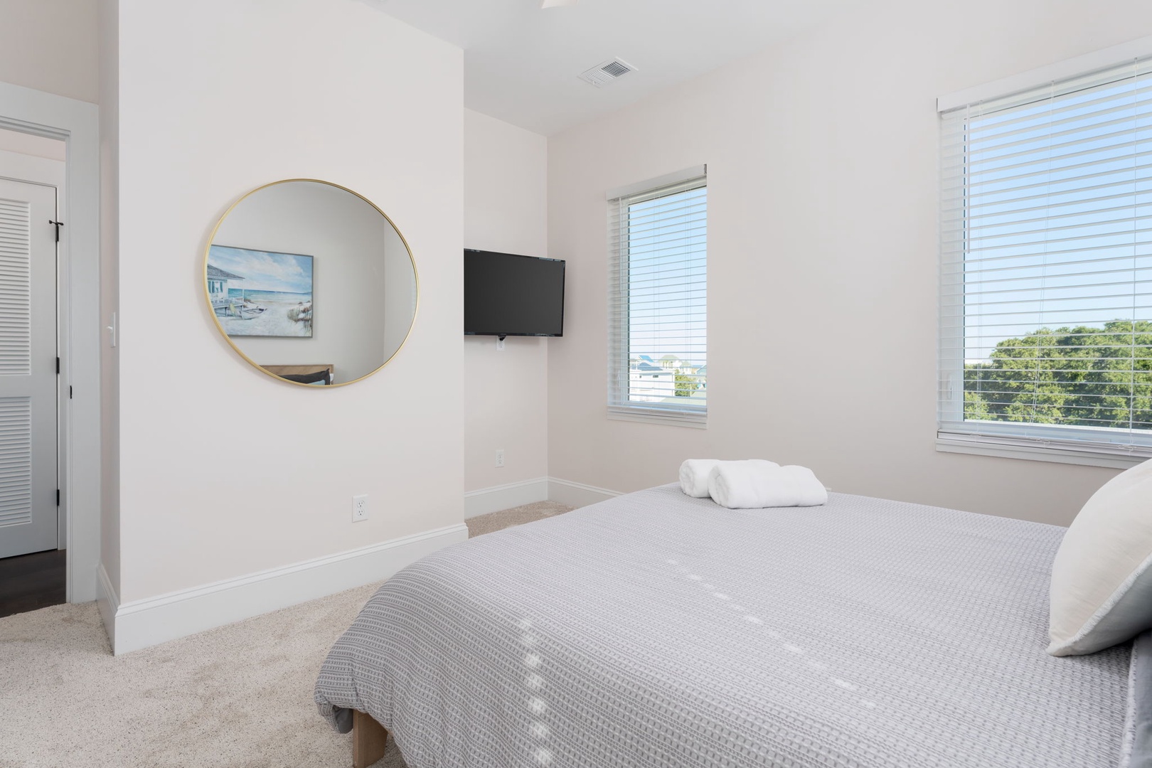 Drift off to sleep in this serene bedroom where soft textures and natural light create your perfect retreat.
