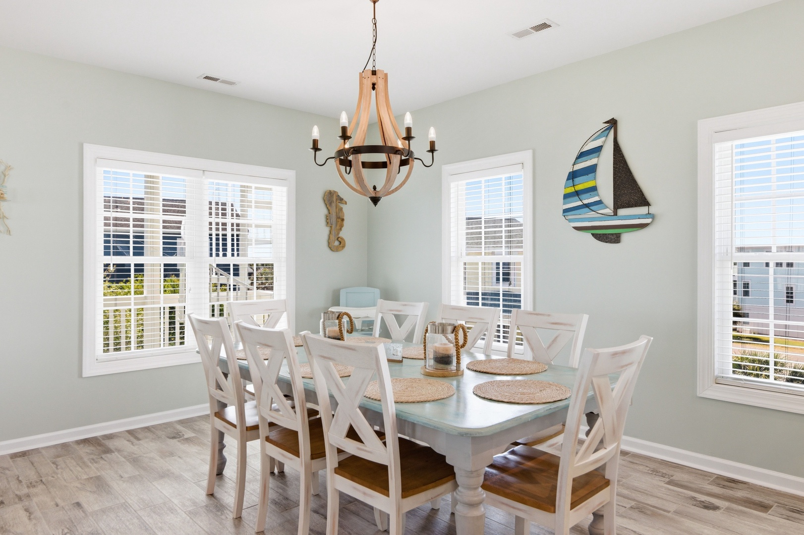 Gather around this bright coastal dining space with seating for eight, where nautical touches and warm natural light create the perfect setting for your group's memorable meals together.