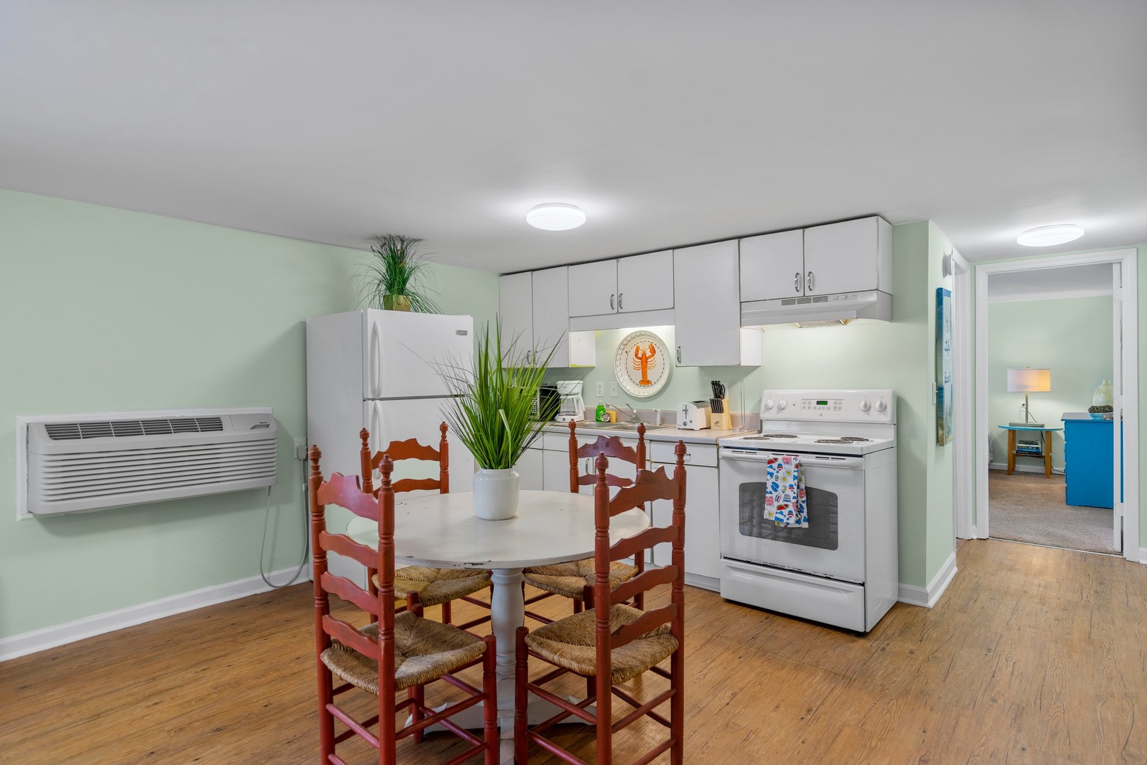 Your fully equipped kitchen and dining area features everything needed for home-cooked meals, with fresh herbs adding a welcoming touch to your stay.