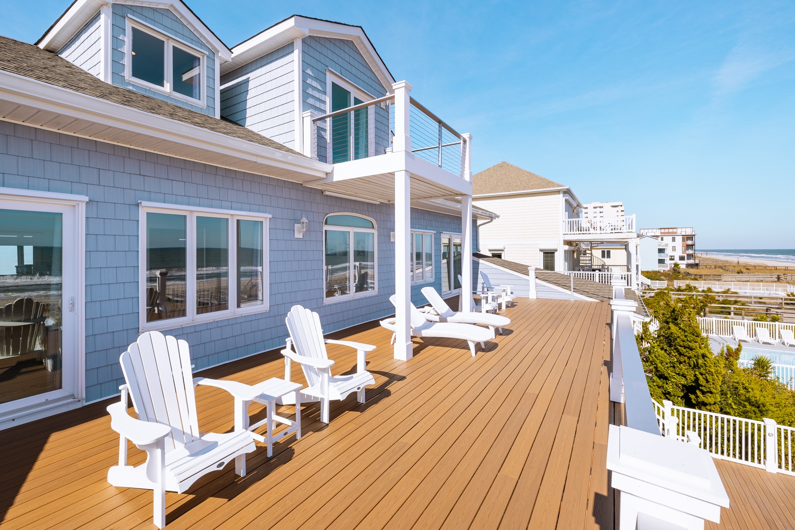 Relax on your private deck with Adirondack chairs and stunning ocean views stretching to the horizon.
