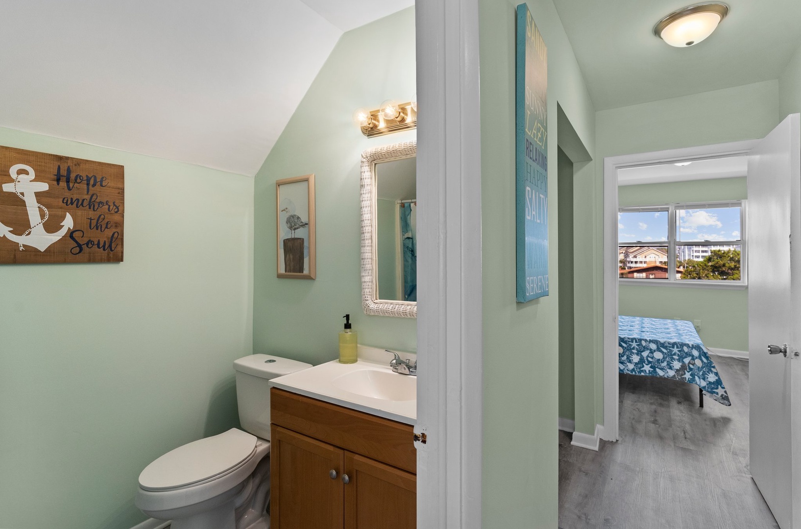 Your private bathroom features coastal charm with soothing sea-green walls, nautical decor, and everything you need for a refreshing start to your day.