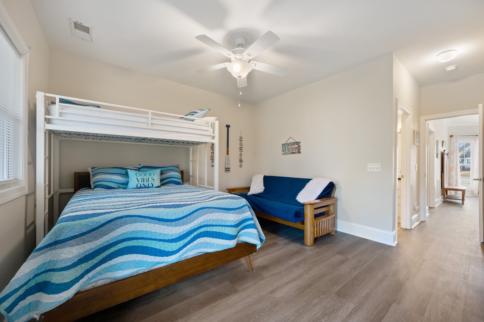 Rest well in this spacious bedroom with a comfortable bunk bed and cozy futon, perfect for flexible sleeping arrangements.