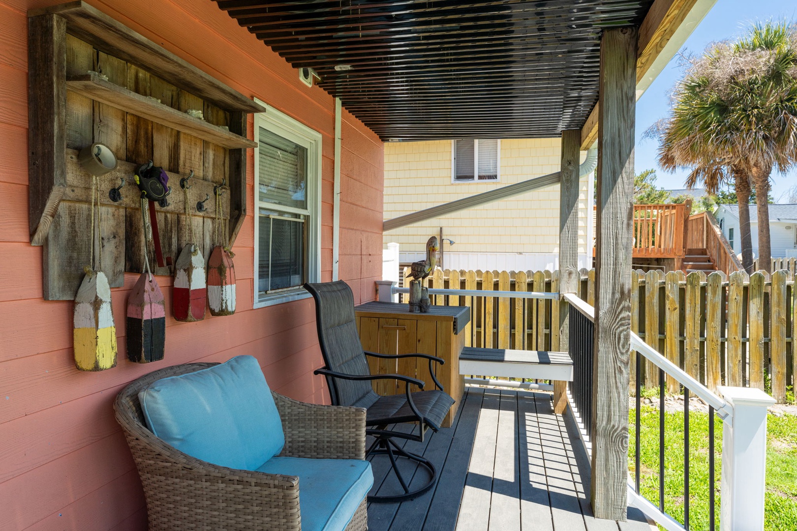 Kick back in your wicker chair and soak up coastal charm—this shaded porch with its playful oar décor and peek-a-boo palm views is your perfect morning coffee or sunset unwind spot.