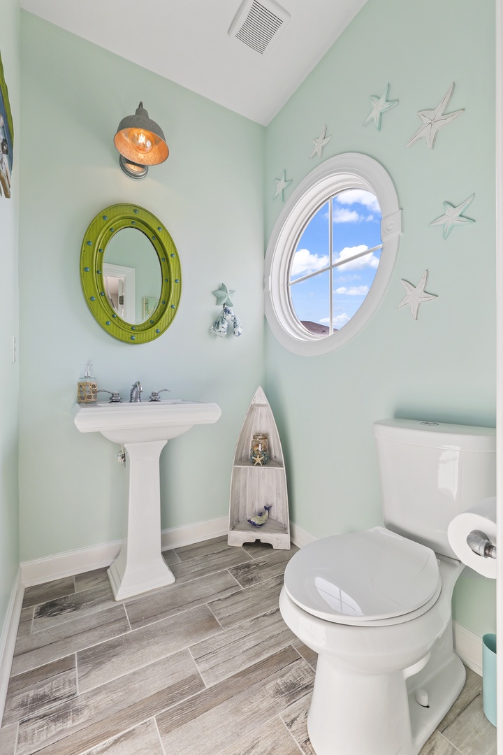 Step into your charming coastal bathroom with soothing seafoam walls, nautical accents, and a bright porthole window that brings natural light into your private space.