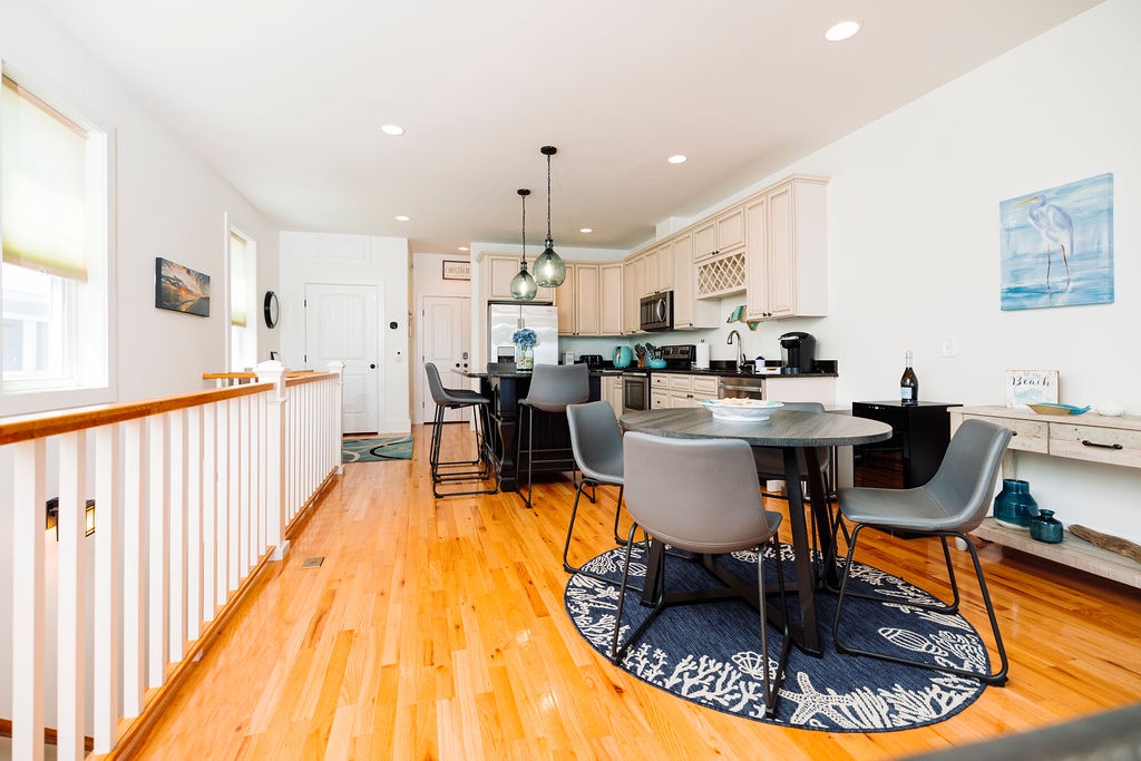 You'll love cooking and dining in this bright, open kitchen with gleaming hardwood floors, modern appliances, and stylish coastal touches throughout.