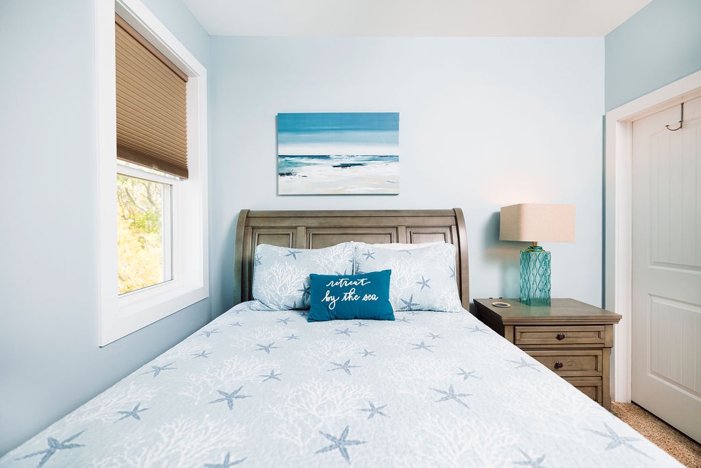 Drift into peaceful sleep surrounded by soft coastal blues and starfish patterns, where ocean artwork and gentle sea breezes create your perfect seaside retreat.