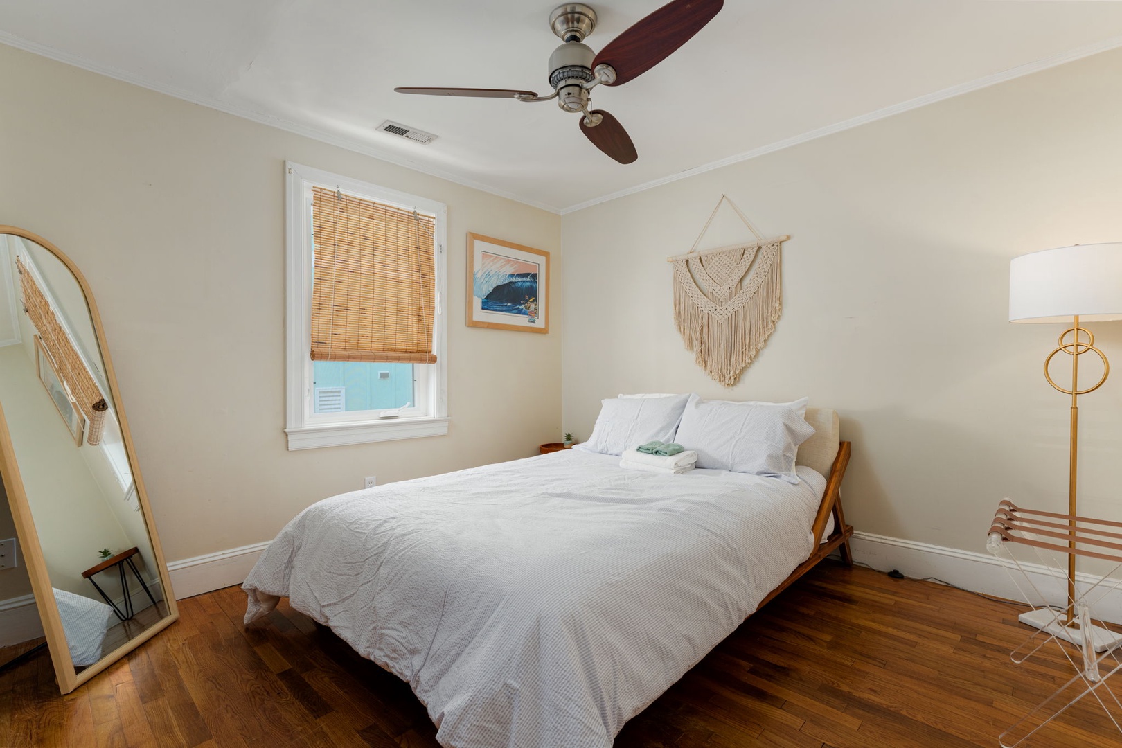 Unwind in your cozy bedroom with crisp linens, natural bamboo blinds, and coastal charm creating the perfect retreat.