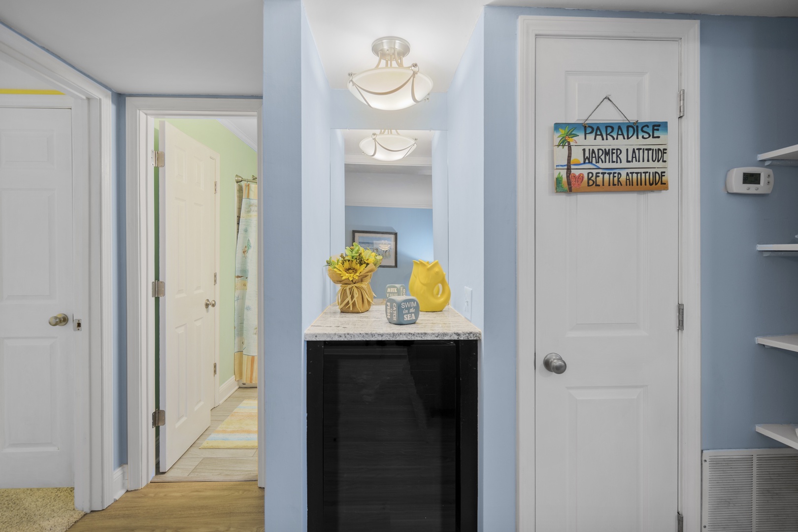 Your bright hallway welcomes you with cheerful coastal colors and thoughtful touches that set the perfect vacation mood.