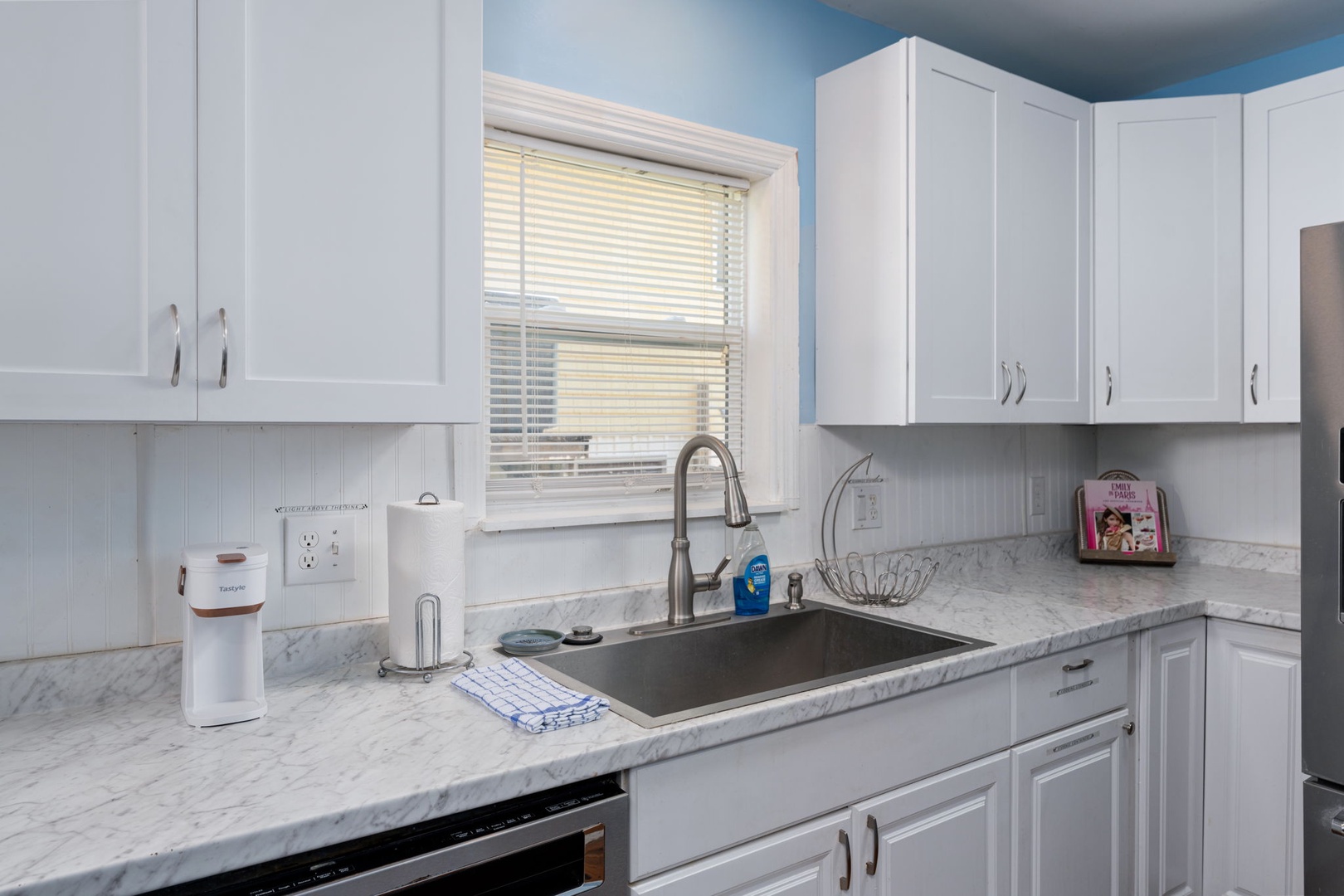 Your bright, fully equipped kitchen has everything you need to prepare meals, with plenty of counter space, crisp white cabinetry, and modern appliances ready for your stay.