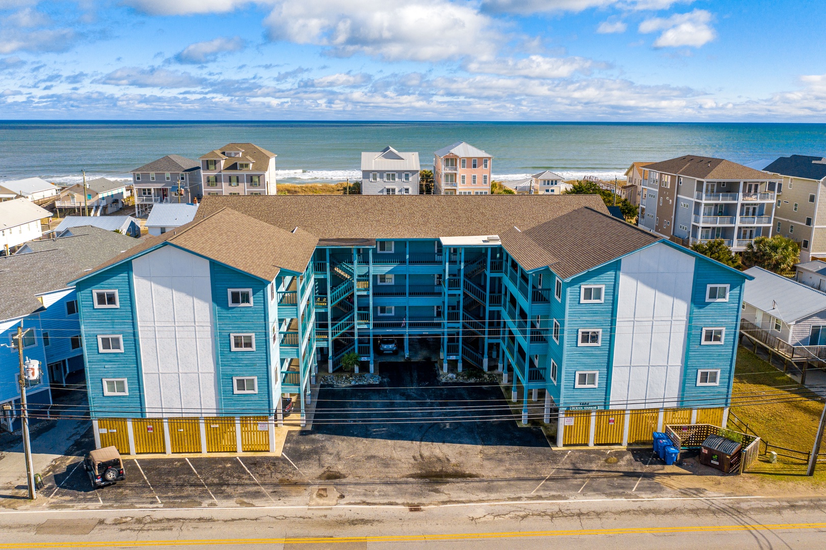 Modern beachfront property featuring distinctive blue architecture just steps from pristine ocean waters and surrounded by coastal charm.