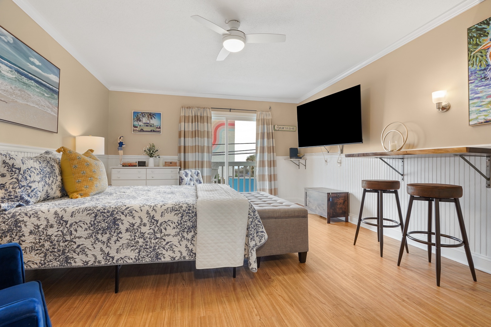 Unwind in your bright, coastal-style bedroom with pool views from your private balcony and modern amenities for the perfect beach getaway.