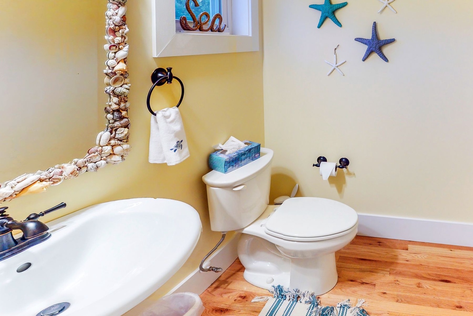 Step into your charming coastal bathroom adorned with seashells, starfish, and ocean-themed touches that transport you to seaside serenity.