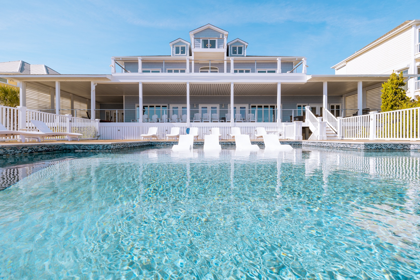 Dive into crystal-clear waters while your beachfront home awaits. This pristine pool offers the perfect retreat between ocean adventures.
