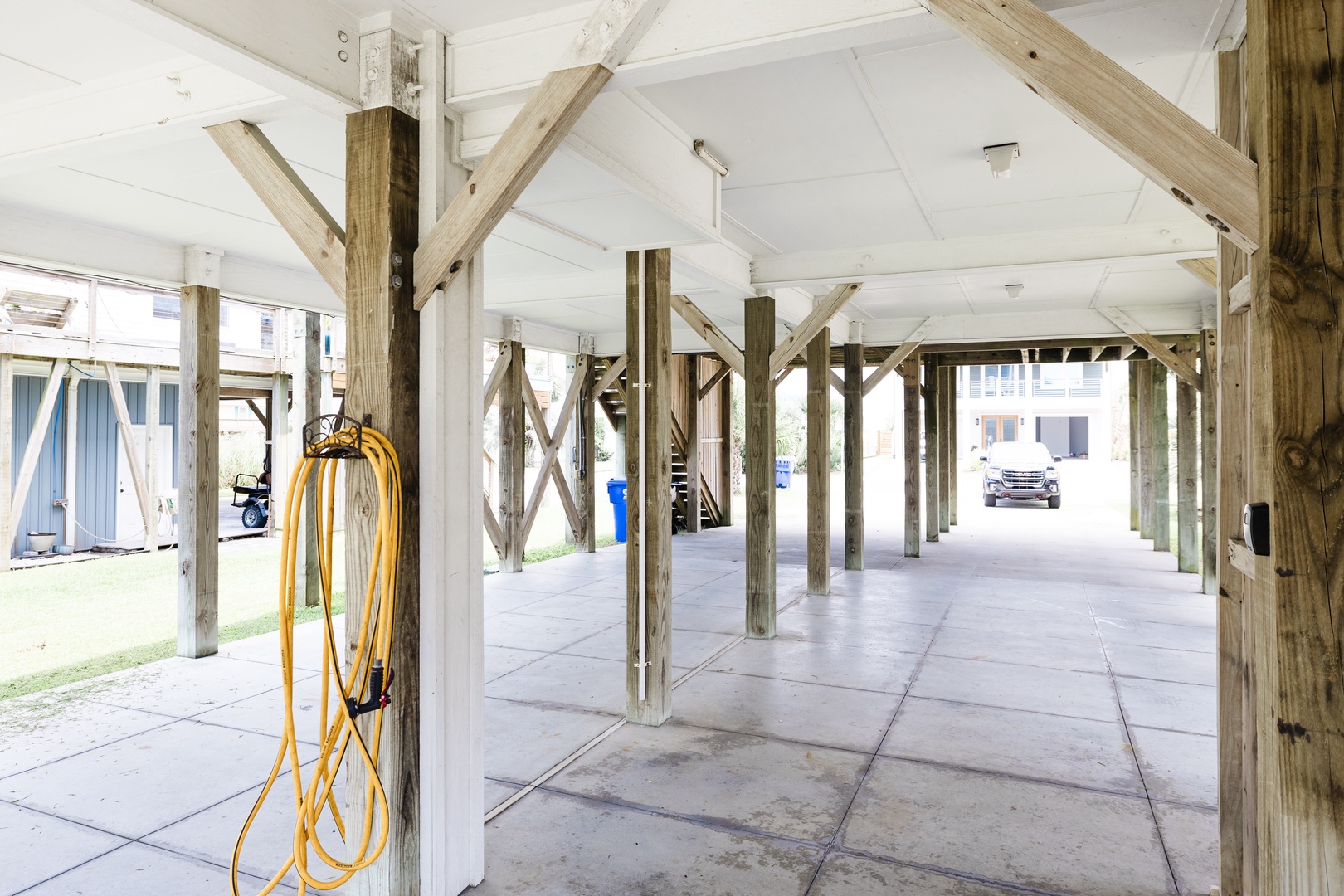 Your covered parking provides excellent protection for your vehicle, with spacious open bays under charming wooden beams.