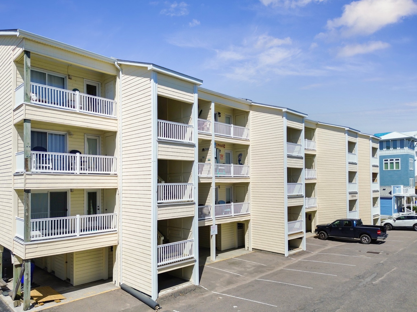 Modern beachside property with multiple levels and balconies, featuring convenient on-site parking in a coastal setting.