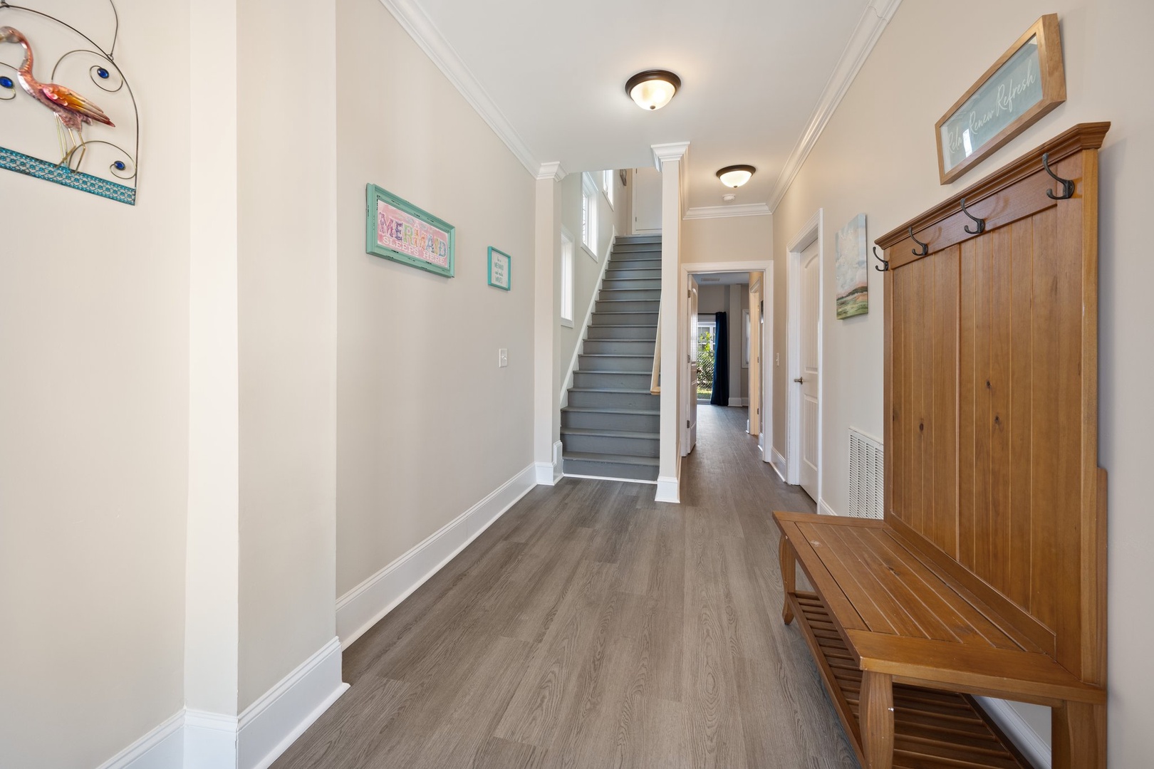 Step into your welcoming entry hall where coastal charm meets comfort—hang your coat and settle in to start your perfect getaway.