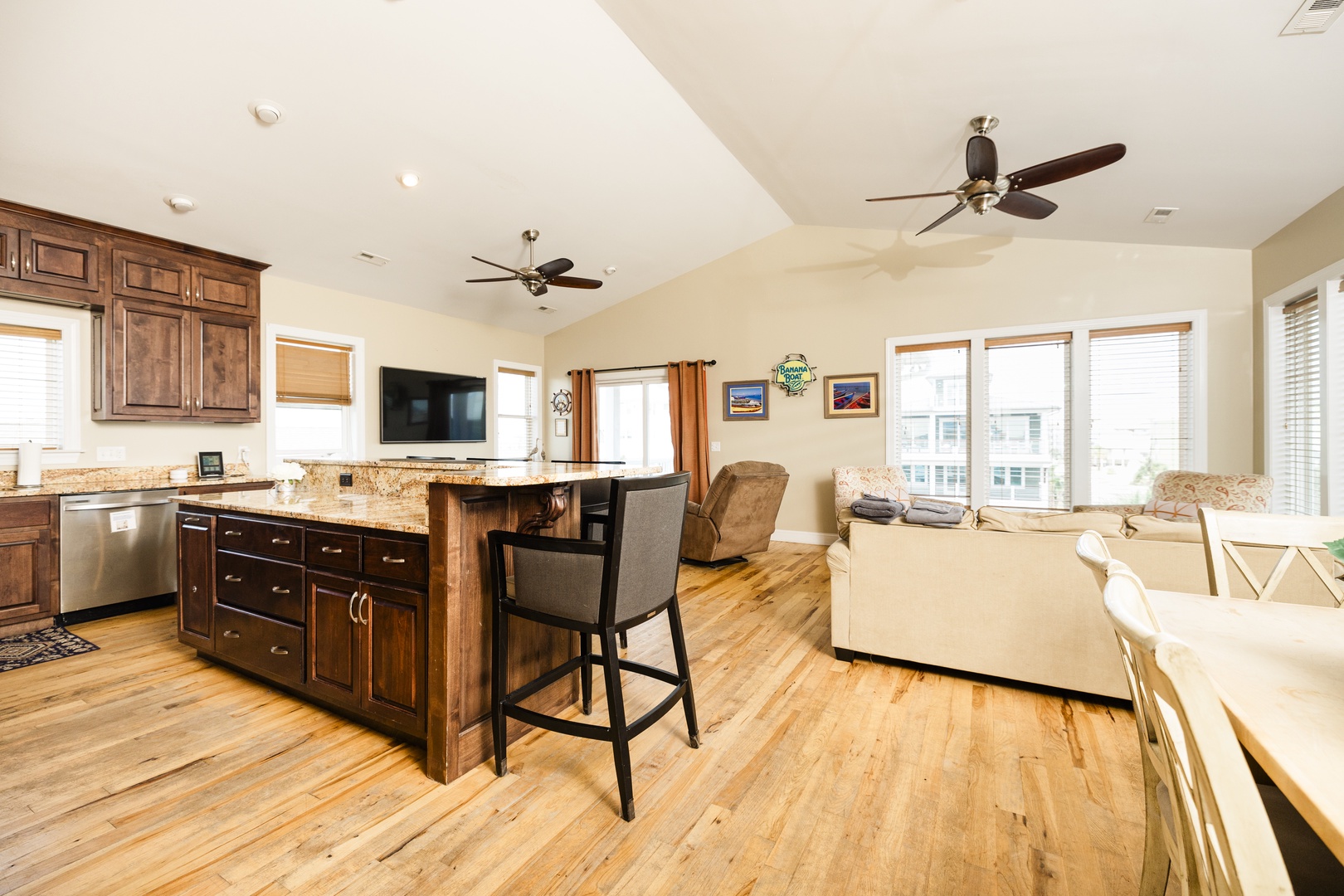 Relax in this open-concept space with hardwood floors, modern kitchen island, and cozy living area perfect for your stay.