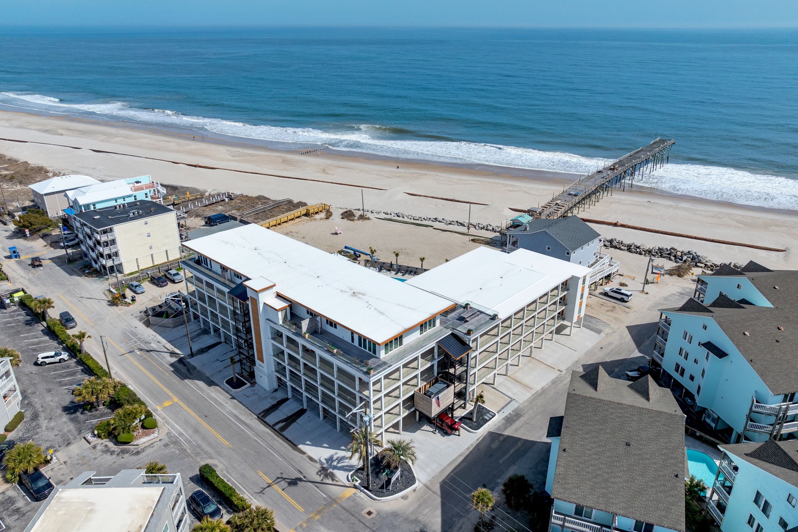 Modern beachfront property with direct beach access, fishing pier, and pristine ocean views in a charming coastal community.