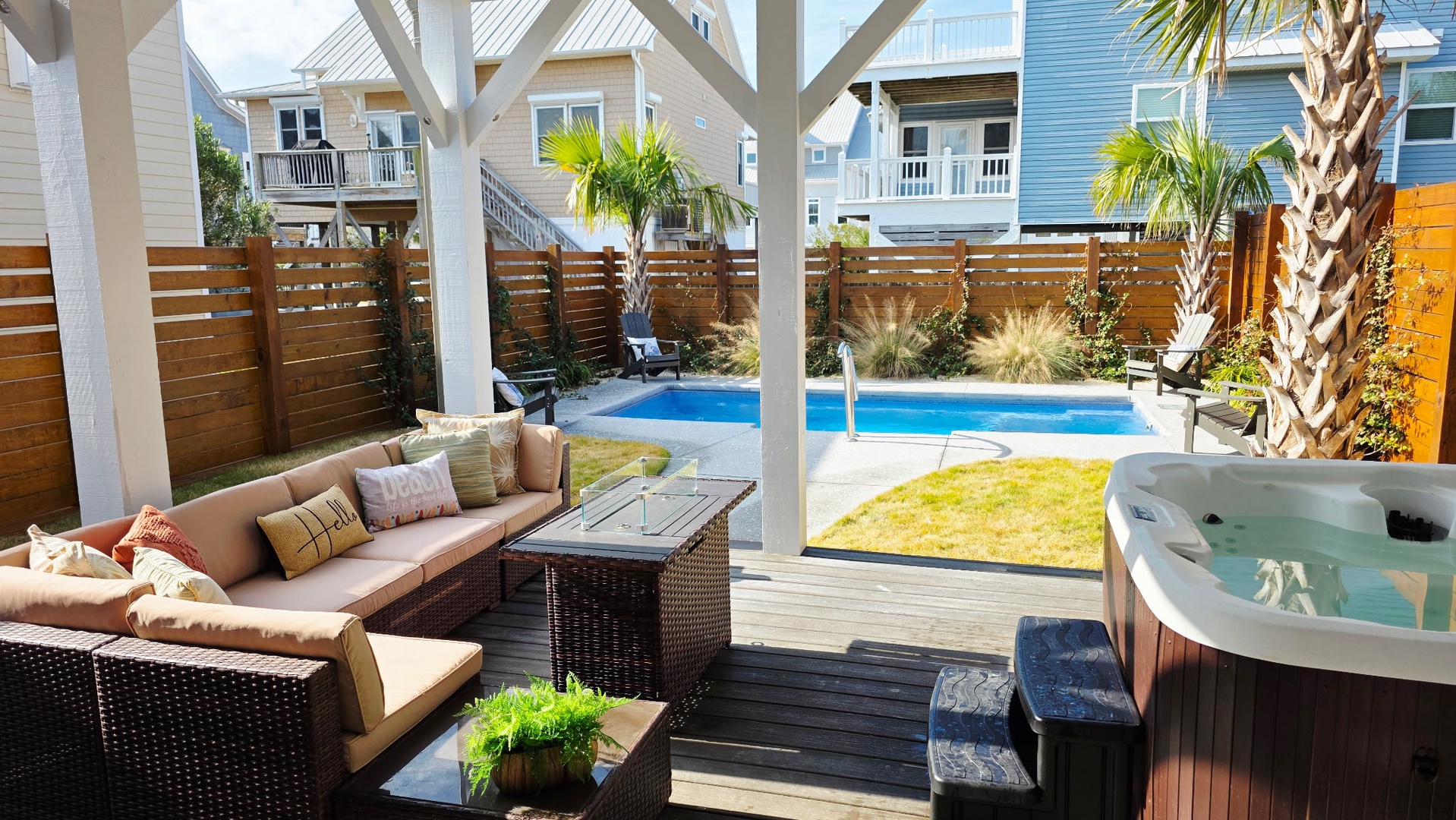 Unwind on your private deck with plush seating overlooking your sparkling pool and hot tub, surrounded by swaying palms.