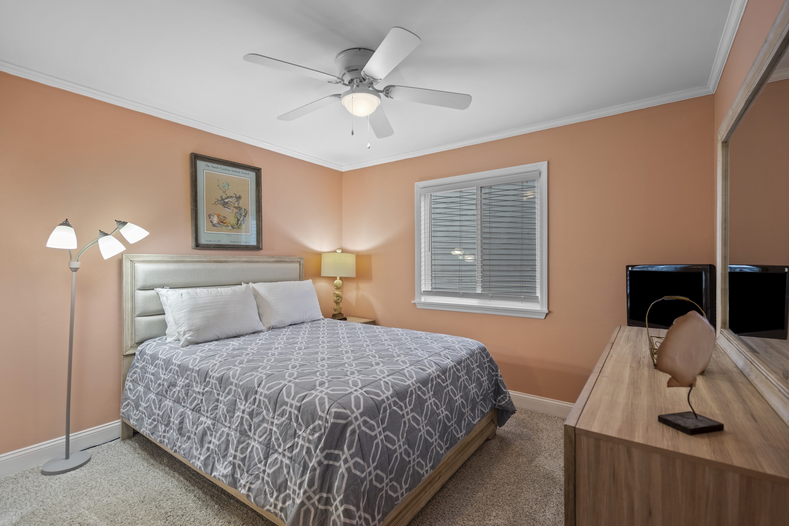 Drift off to sleep in your cozy bedroom, complete with soft linens, gentle ceiling fan, and warm lighting for ultimate relaxation.