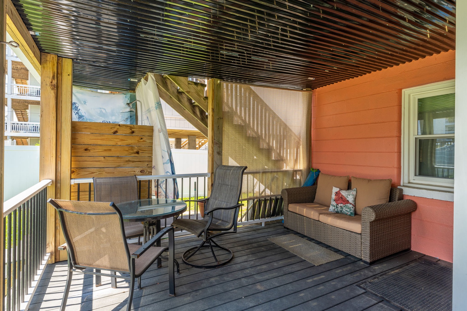 Relax on your private covered deck with comfy seating and stunning rainbow-striped ceiling that creates a cheerful outdoor retreat for morning coffee or evening unwind time.