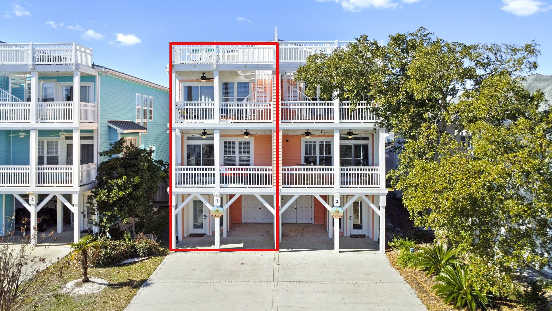 This coastal beach house offers elevated living with multiple levels, balconies, and convenient ground-level parking in a charming neighborhood setting.