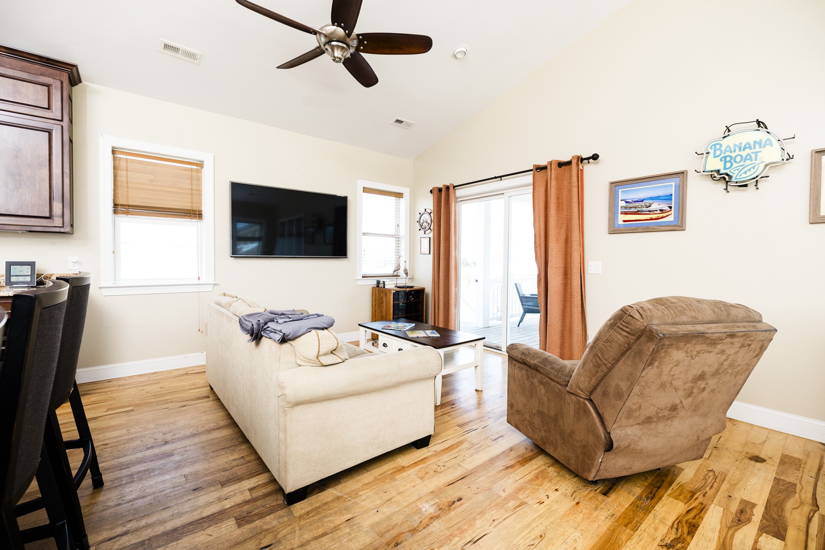 Unwind in your cozy living room with plush seating, entertainment, and coastal charm for perfect relaxation.