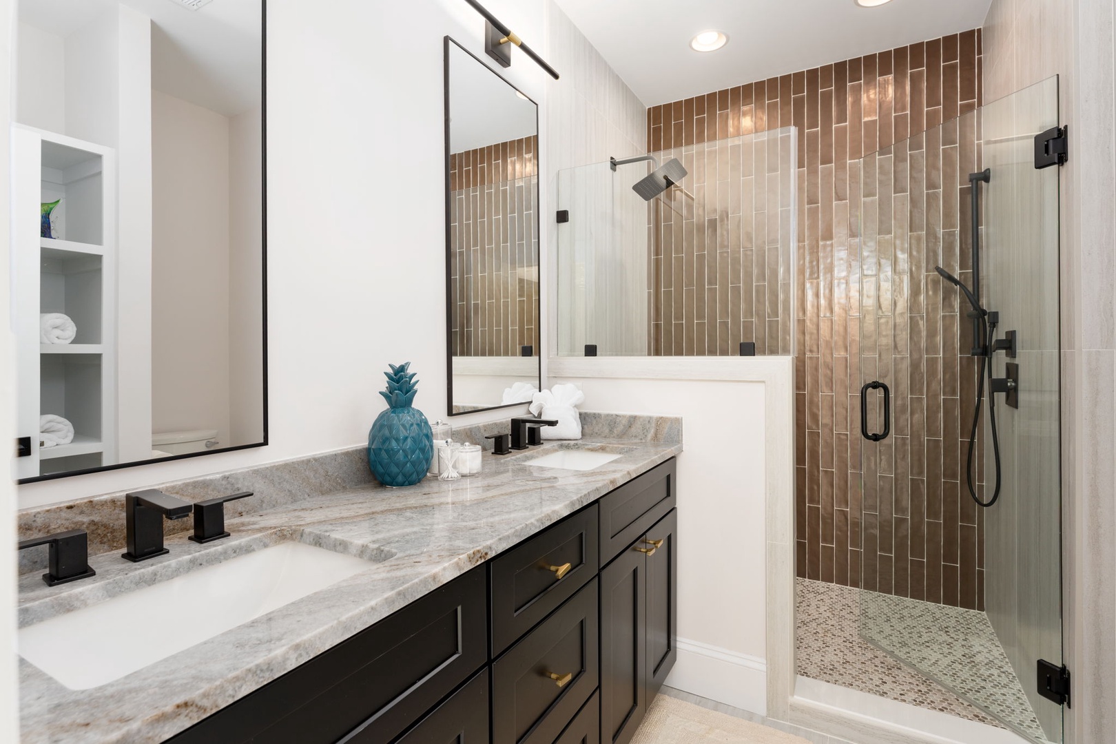 Unwind in your luxurious ensuite with marble countertops, elegant glass shower, and warm wood accent tiles creating a spa-like retreat.