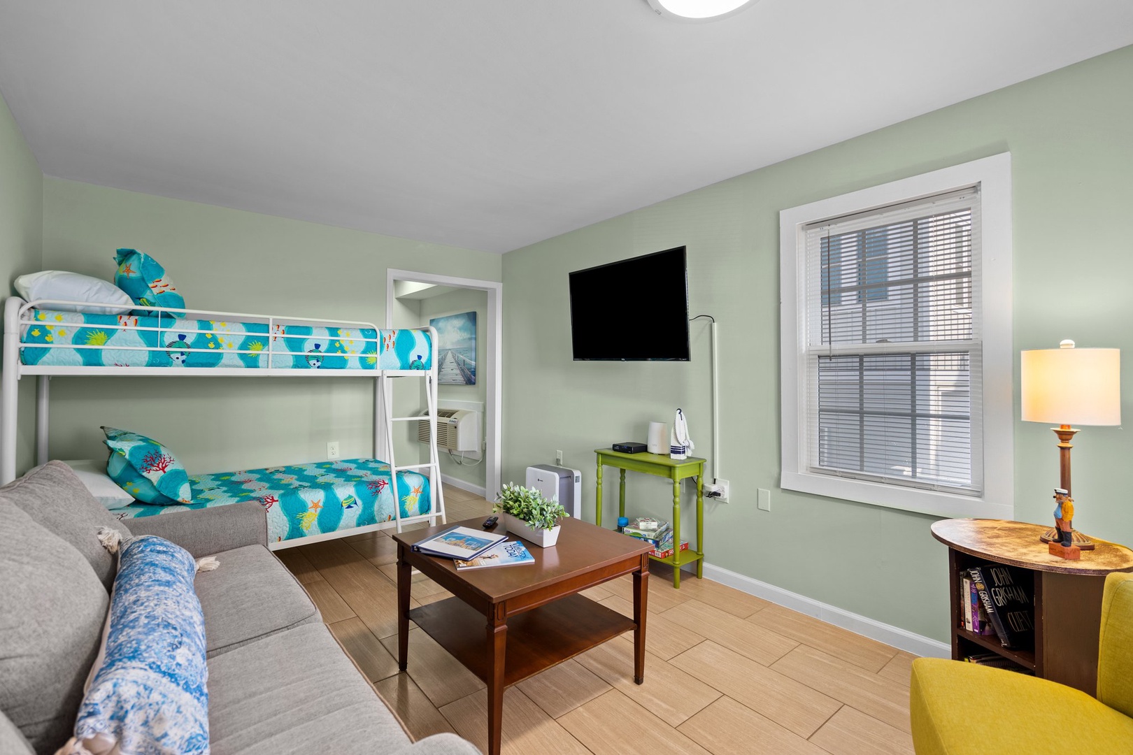 Unwind in your cozy retreat with fun bunk beds and relaxing seating area, perfect for families seeking comfort and entertainment.