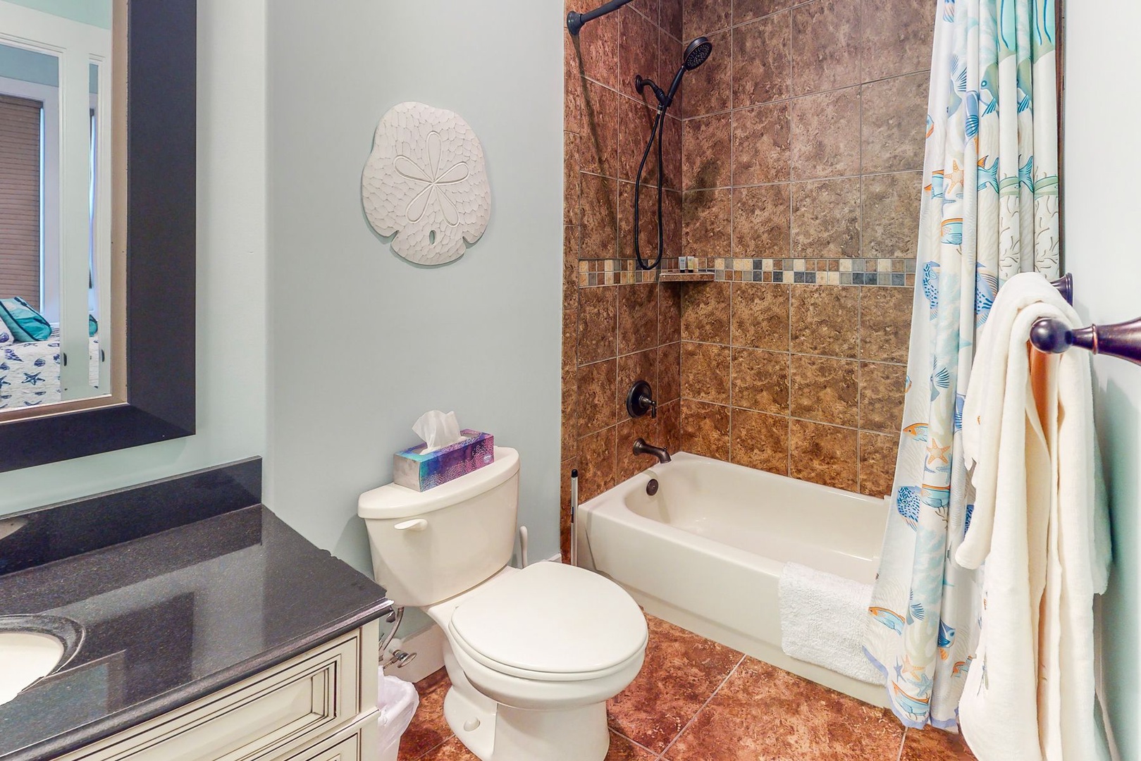 Refresh in your elegant bathroom featuring beautiful tile work, a relaxing tub-shower combo, and thoughtful coastal touches throughout.