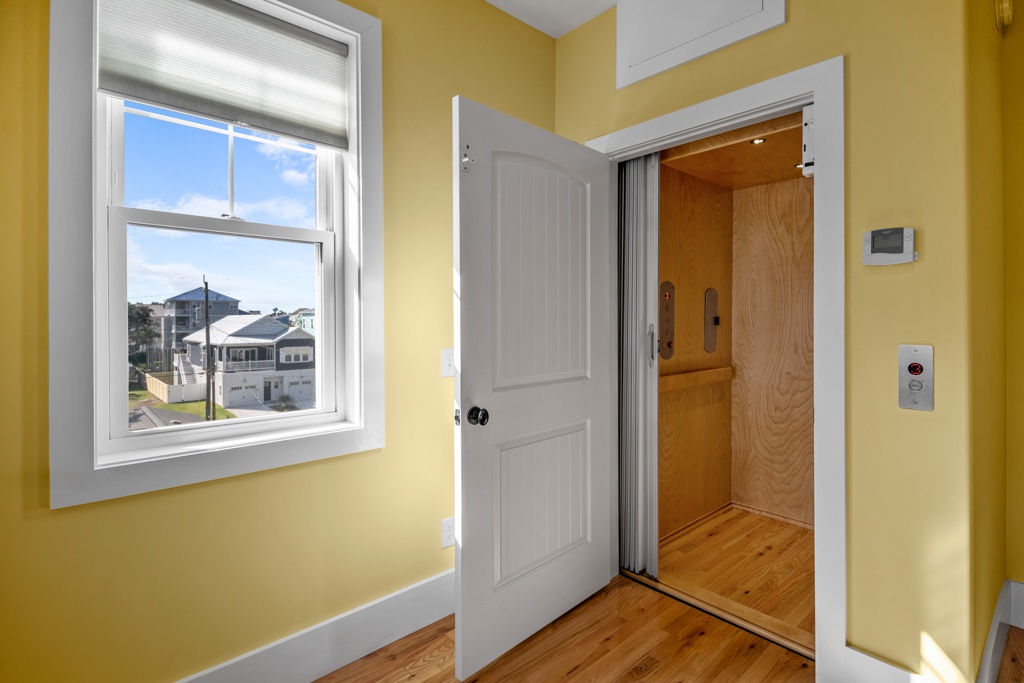 Step into your cheerful yellow-walled space with elevator access and charming neighborhood views from your window.